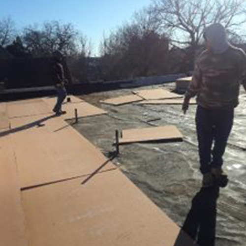 men working on a commercial roof